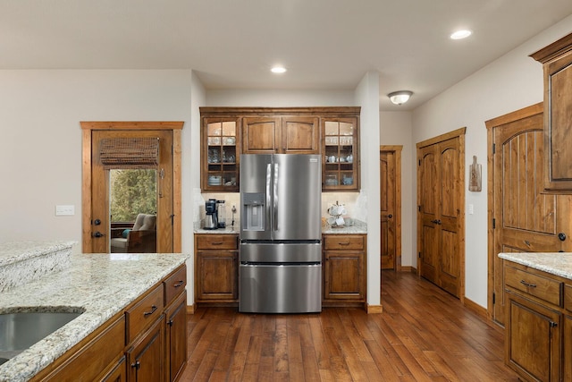 kitchen featuring tasteful backsplash, sink, dark hardwood / wood-style flooring, light stone counters, and stainless steel refrigerator with ice dispenser