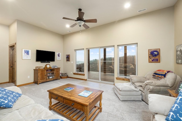 carpeted living room featuring a high ceiling and ceiling fan