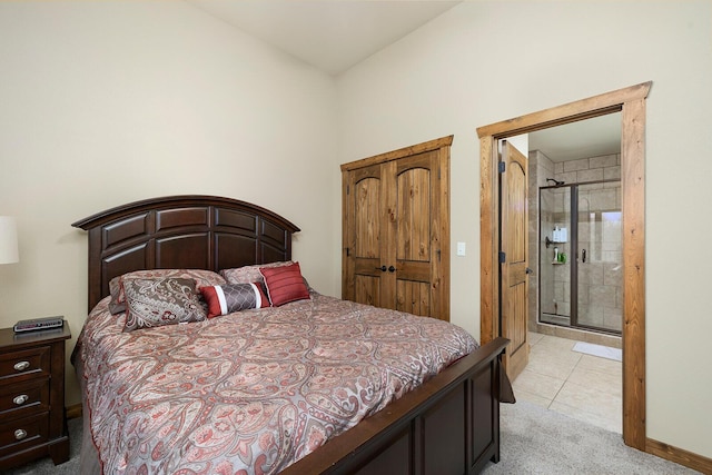 bedroom with connected bathroom and light carpet