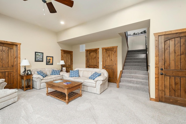 carpeted living room featuring ceiling fan