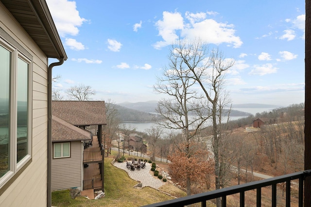 balcony featuring a water and mountain view