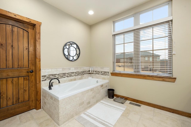 bathroom featuring a relaxing tiled tub