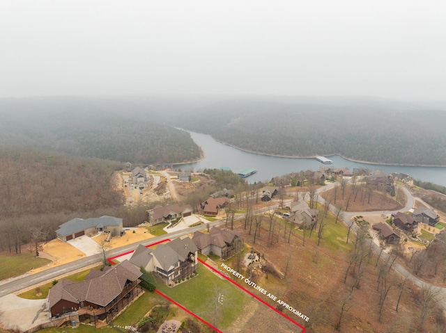 birds eye view of property featuring a water view