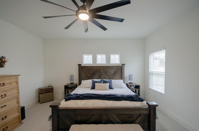 bedroom featuring light carpet and ceiling fan