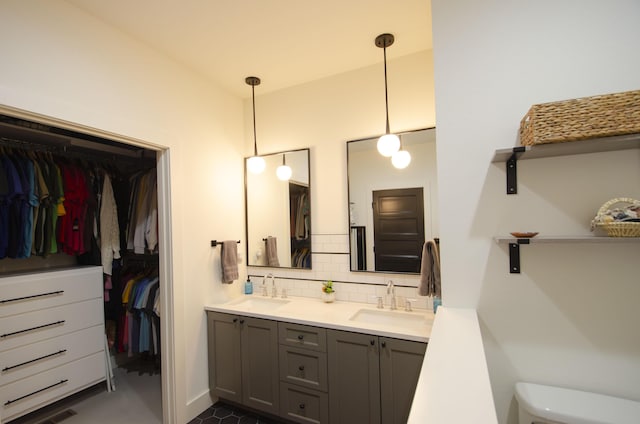 bathroom featuring tasteful backsplash, vanity, and toilet