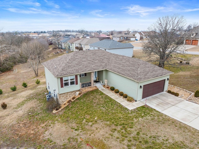 ranch-style home featuring a garage, a front yard, and cooling unit