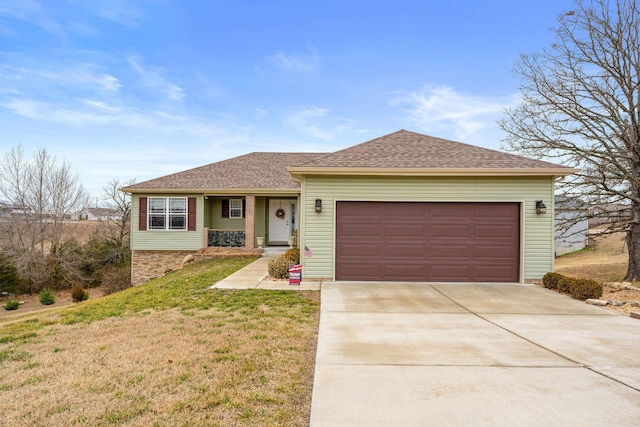 ranch-style house featuring a garage and a front yard