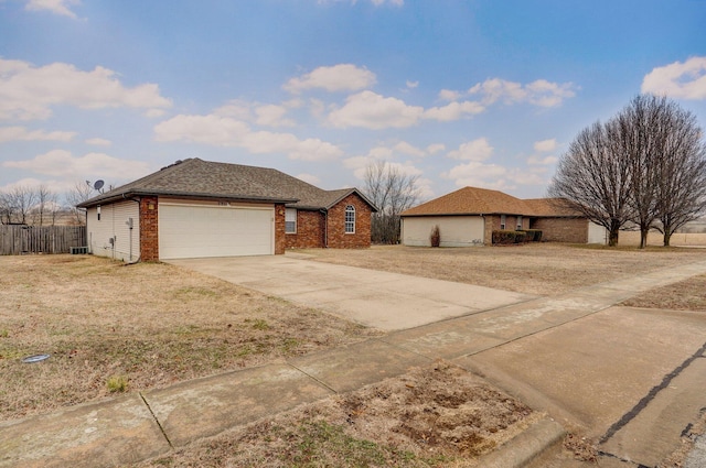 single story home featuring a garage and a front lawn