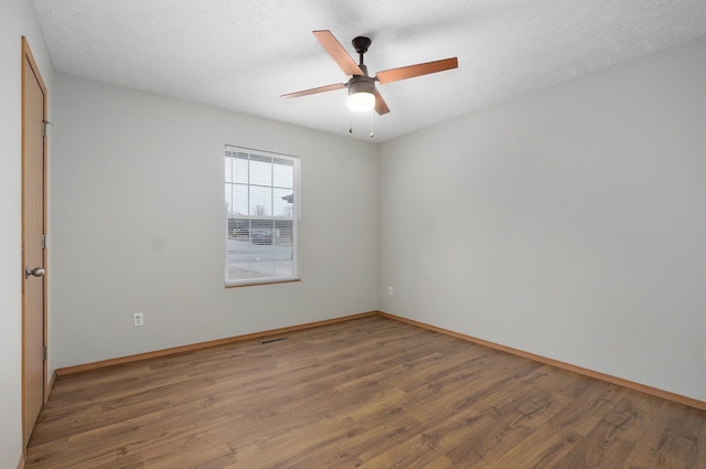 unfurnished room featuring a textured ceiling, wood-type flooring, and ceiling fan