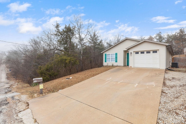 view of front of house with a garage and cooling unit