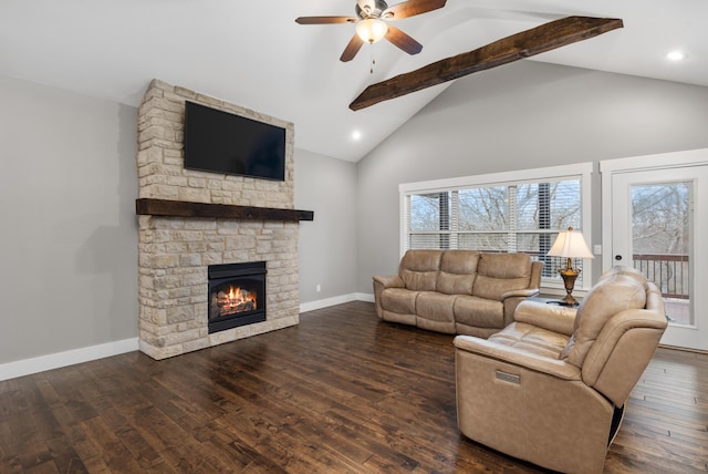 living room with dark wood-type flooring, ceiling fan, beam ceiling, high vaulted ceiling, and a stone fireplace