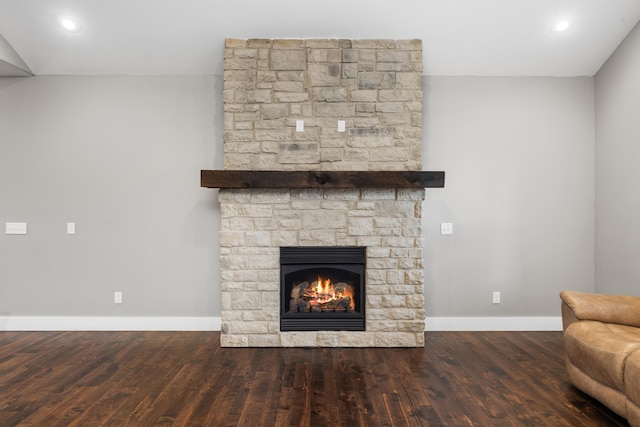 unfurnished living room with dark wood-type flooring and a fireplace