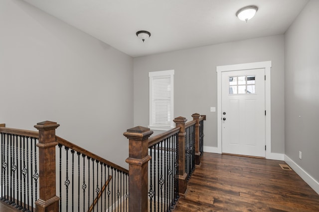 foyer entrance with dark hardwood / wood-style floors