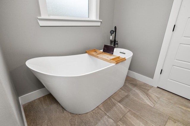 bathroom with a tub to relax in