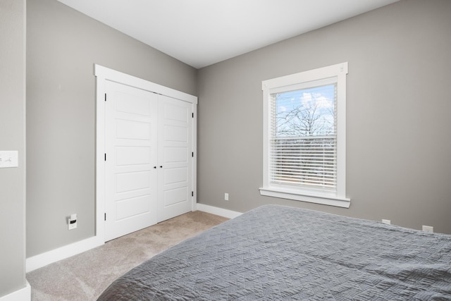 carpeted bedroom with a closet