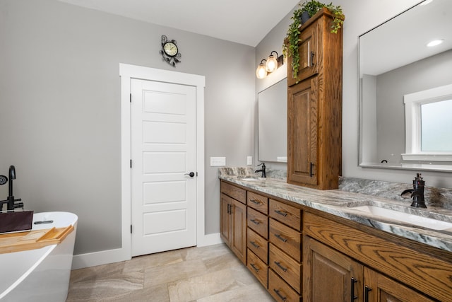 bathroom with vanity and a washtub