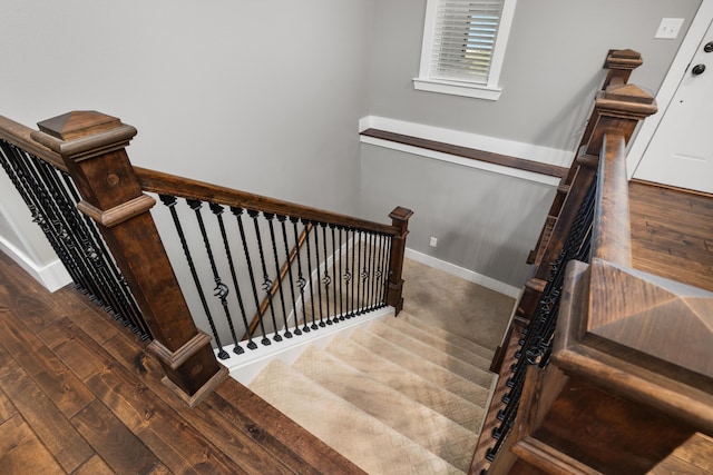 stairs with hardwood / wood-style floors