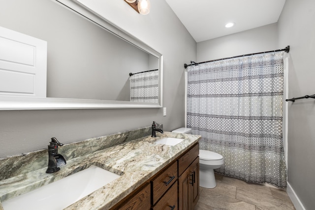 bathroom with vanity, toilet, and a shower with shower curtain