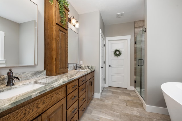 bathroom with vanity and shower with separate bathtub