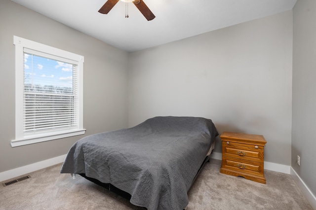 bedroom featuring ceiling fan and light carpet