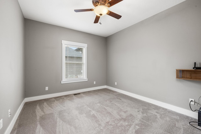 empty room featuring light carpet and ceiling fan