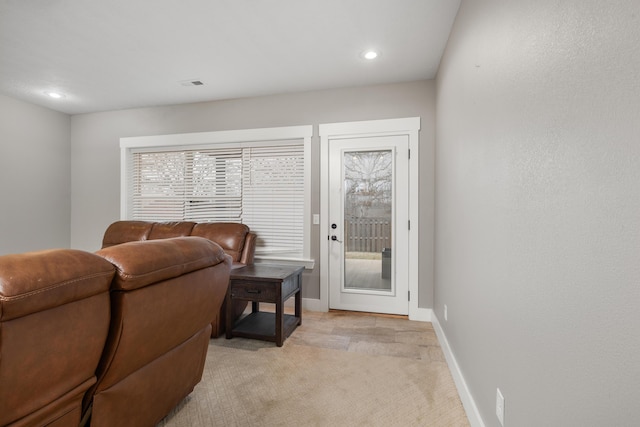 carpeted living room featuring a healthy amount of sunlight