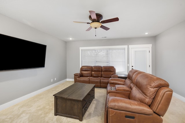 living room with light carpet and ceiling fan