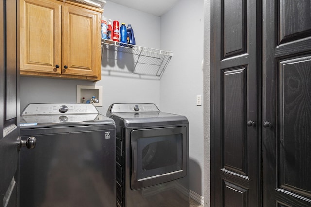 laundry area featuring cabinets and washing machine and clothes dryer