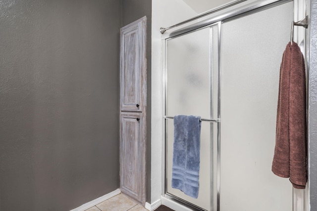 bathroom with tile patterned floors and walk in shower