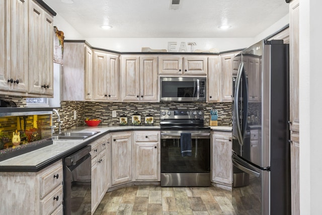 kitchen featuring stainless steel appliances, sink, and light brown cabinets