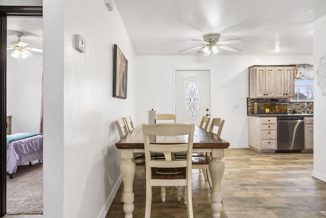 dining area featuring ceiling fan and light wood-type flooring