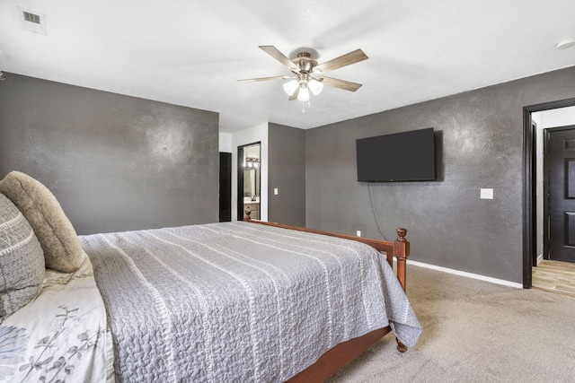 carpeted bedroom with connected bathroom and ceiling fan