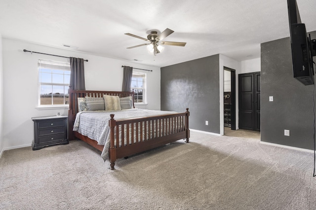 carpeted bedroom with a textured ceiling and ceiling fan