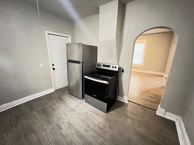 kitchen with dark wood-type flooring and appliances with stainless steel finishes