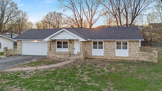 ranch-style house featuring a garage, driveway, a shingled roof, and fence