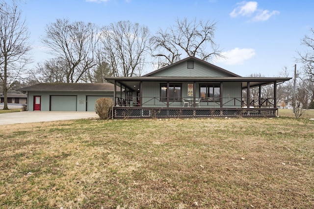 view of front of home featuring a garage, a front yard, and covered porch