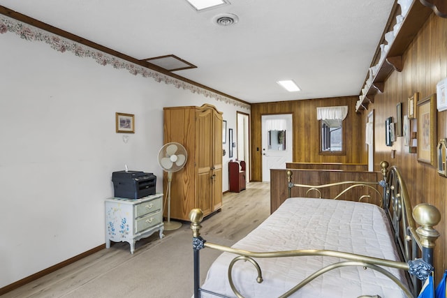 bedroom with wood walls