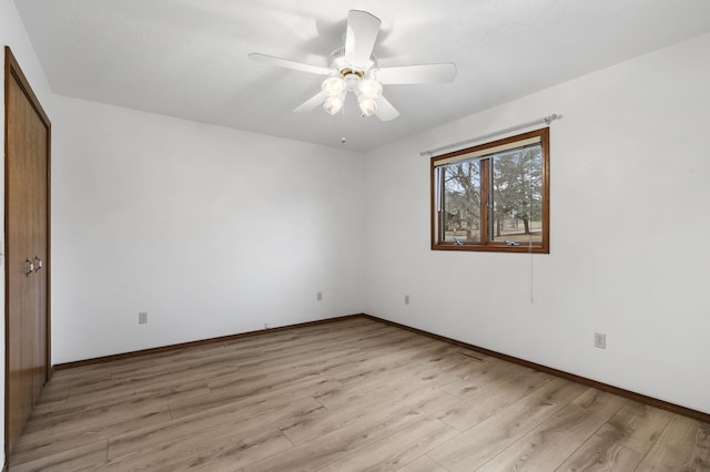 empty room with ceiling fan and light wood-type flooring