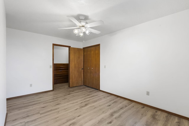 empty room with ceiling fan and light hardwood / wood-style floors