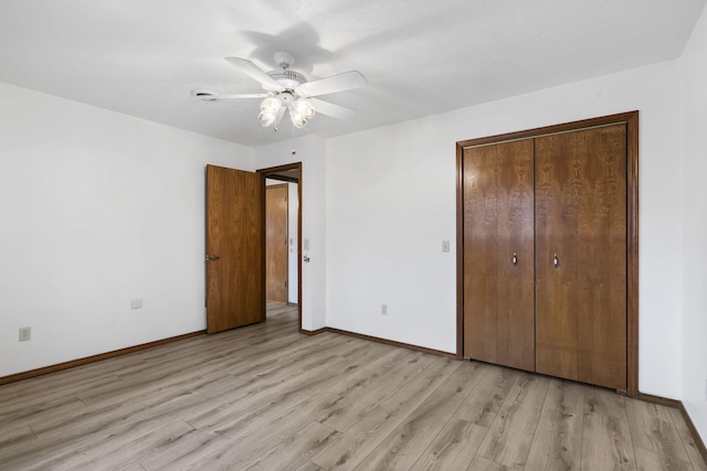 unfurnished bedroom featuring light hardwood / wood-style floors, a closet, and ceiling fan