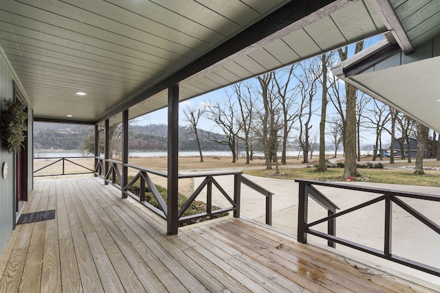 wooden terrace featuring a water view