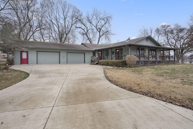 ranch-style home with a porch, a garage, and a front yard