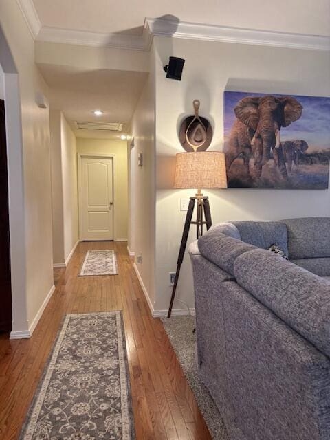 corridor with crown molding and hardwood / wood-style floors