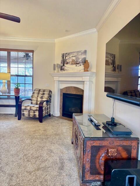 living room featuring crown molding and carpet flooring