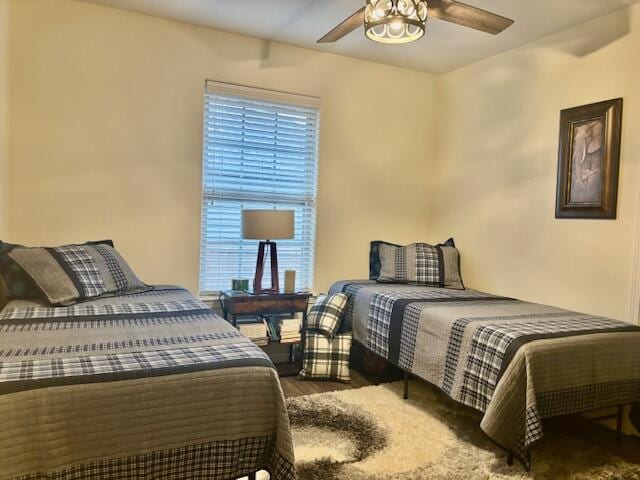 bedroom with ceiling fan and wood-type flooring