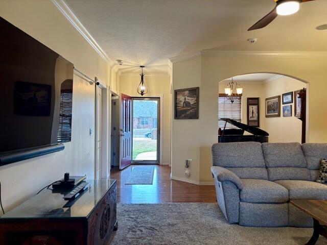 foyer with ceiling fan and ornamental molding