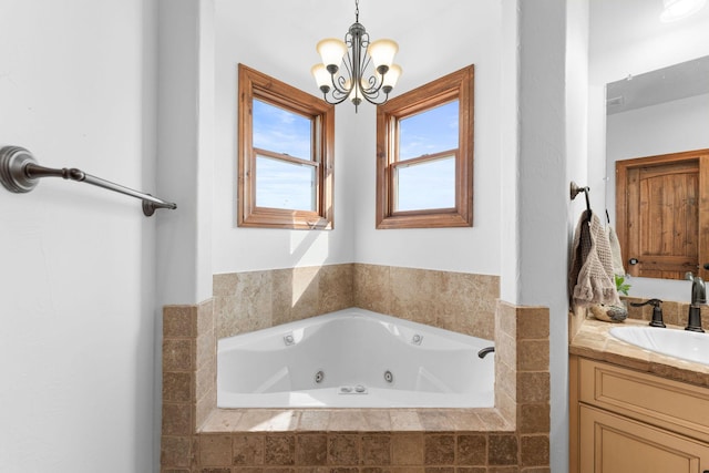 bathroom featuring vanity, a relaxing tiled tub, and a notable chandelier