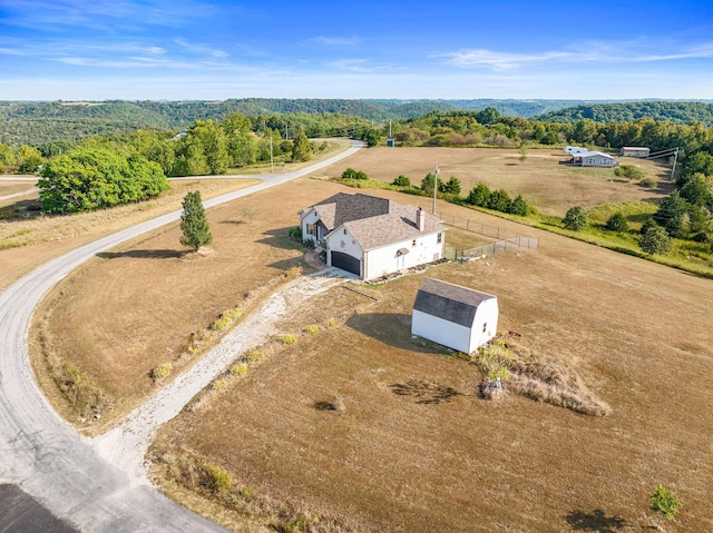 birds eye view of property with a rural view