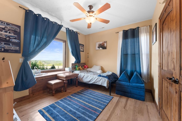 bedroom with hardwood / wood-style flooring and ceiling fan