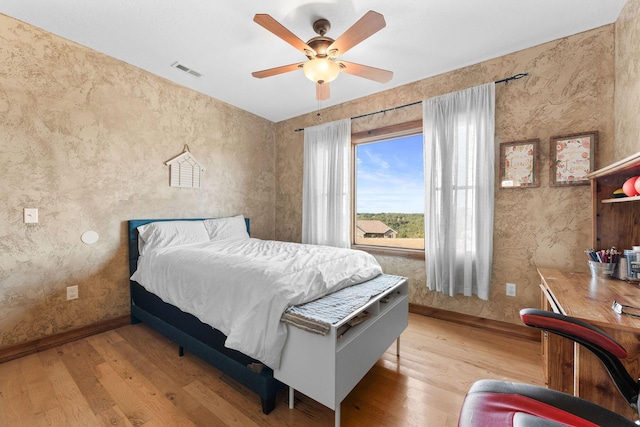 bedroom with ceiling fan and light hardwood / wood-style floors